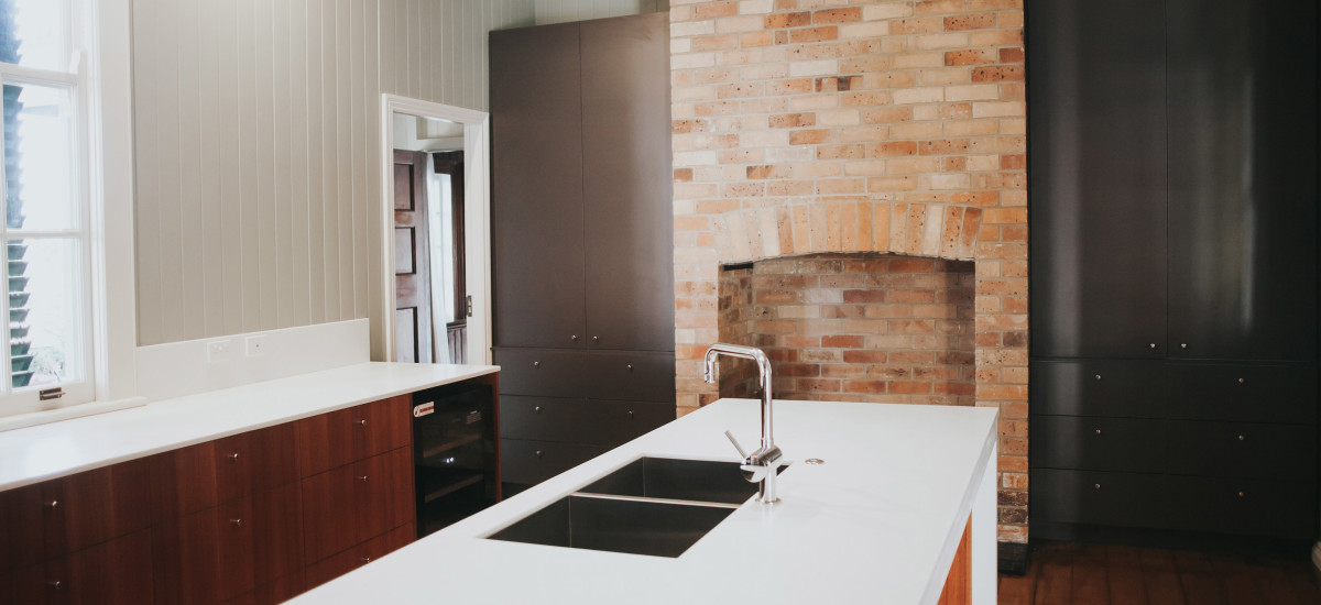 Simplistic kitchen with brick fireplace