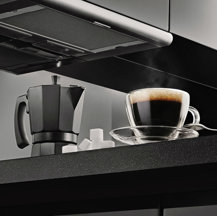 Modern black kitchen with coffee brewing