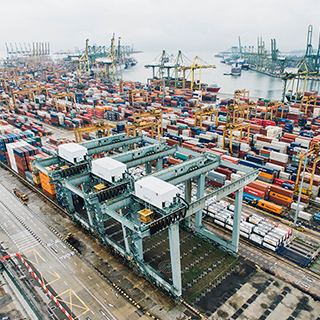 Shipping containers on a dock with cranes