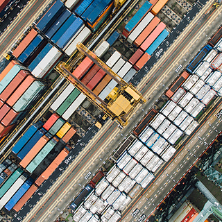 Aerial view of multiple shipping containers and a boat