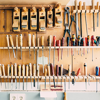 Tools hung on neatly on the wall of a workshop